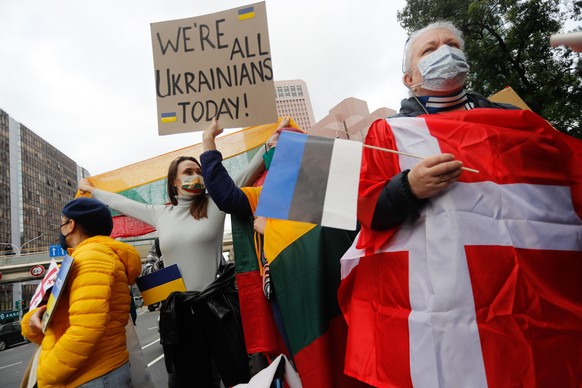 Demonstrators holding placards that read âWe are all Ukrainians todayâ, and national flags of Ukraine, Denmark, Estonia and Lithuania, during a protest against Russian live-fire attacks on Ukraine ...