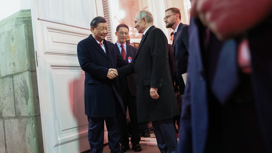 Chinese President Xi Jinping, left, shakes hands with Russian President Vladimir Putin as he leaves after their dinner at The Palace of the Facets in the Moscow Kremlin, Russia, Tuesday, March 21, 202 ...