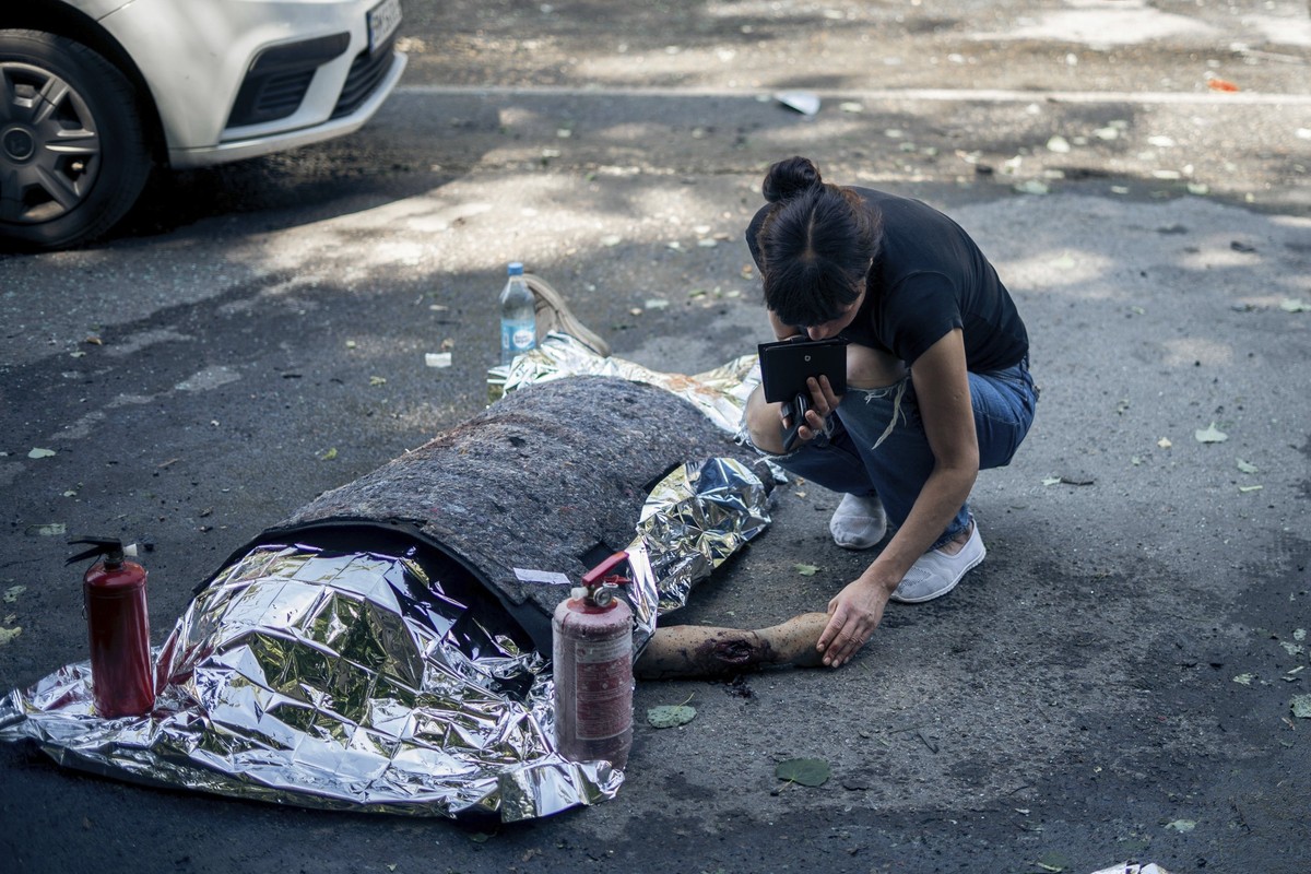 A woman touches the body of a relative killed in a Russian strike on Sumy, Ukraine, on Tuesday, June 3, 2025. (AP Photo/Yehor Kryvoruchko, Kordon Media)