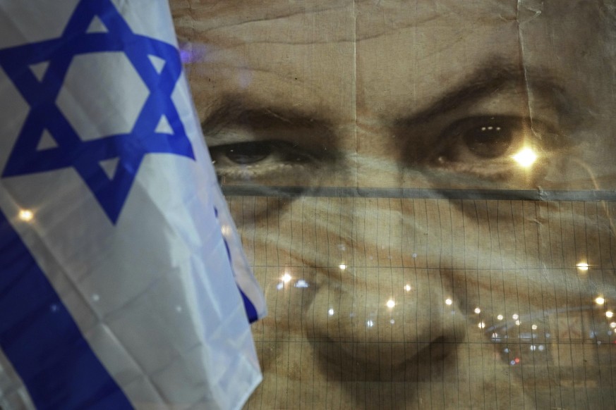 A banner depicting Israeli Prime Minister Benjamin Netanyahu is seenn during a protest against his far-right government, in Tel Aviv, Israel, Saturday, Jan. 21, 2023. Last week, tens of thousands of I ...