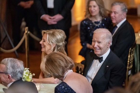 President Joe Biden and first lady Jill Biden laugh during a reception for members of the National Governors Association and their spouses in the East Room of the White House in Washington, Saturday,  ...