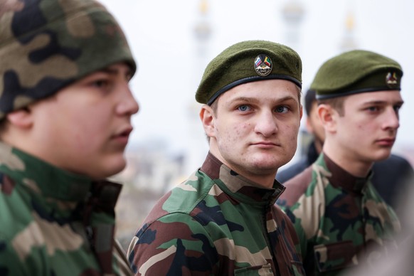 GROZNY, CHECHEN REPUBLIC, RUSSIA - FEBRUARY 25, 2022: Chechen Republic Head Ramzan Kadyrovs sons Adam, Akhmed, Eli L-R attend a review of the Chechen Republic s troops and military hardware at the res ...