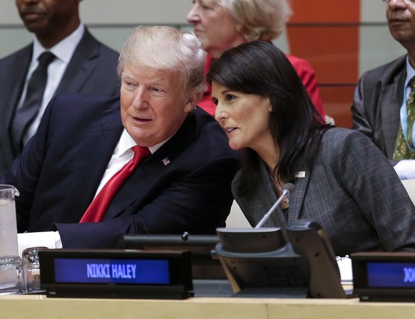 FILE - President Donald Trump speaks with U.S. Ambassador to the United Nations Nikki Haley before a meeting during the United Nations General Assembly at U.N. headquarters, Sept. 18, 2017. Haley, the ...