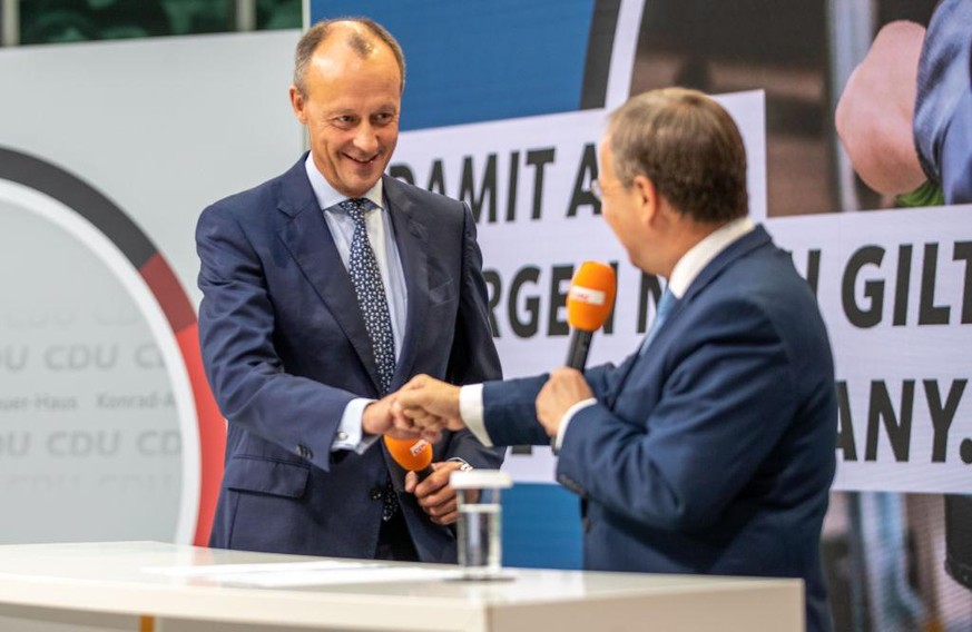 BERLIN, GERMANY - SEPTEMBER 03: Ex-Union parliamentary group leader Friedrich Merz (L) speaks as Armin Laschet, chancellor candidate of the German Christian Democrats (CDU), presents his eight-member  ...