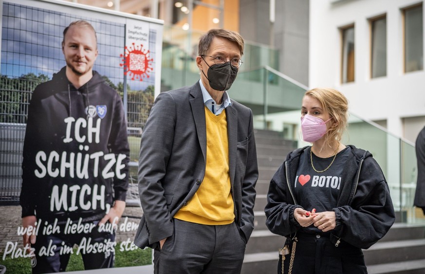 14.10.2022, Berlin: Karl Lauterbach (SPD, l), Bundesminister für Gesundheit, steht neben Margarete Stokowski, Journalistin, Autorin und Long-Covid-Betroffene, nach einer Pressekonferenz zur aktuellen  ...