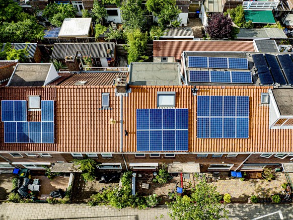 UTRECHT - Solar panels on roofs in a residential area in Utrecht. More and more people are making their homes more sustainable. Robin Utrecht