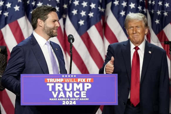 Republican presidential nominee former President Donald Trump gives a thumbs-up as Republican vice presidential nominee Sen. JD Vance, R-Ohio, speaks at an election night watch party, Wednesday, Nov.  ...