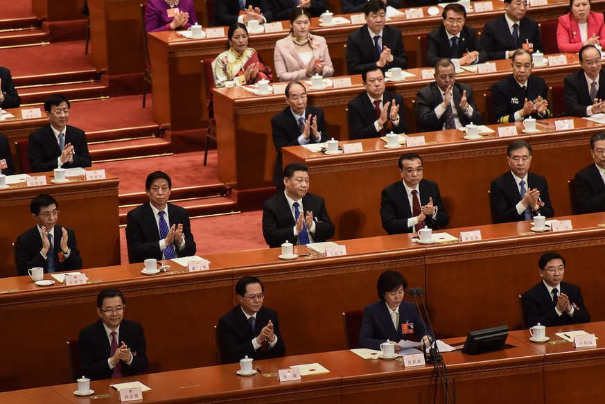 BEIJING, CHINA - MARCH 18: (second raw) Chinese President Xi Jinping (C), Chinese Premier Li Keqiang (2-R) and Chairman of the National People&#039;s Congress Li Zhanshu (2-L) applaud with other membe ...