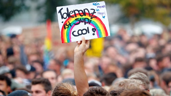 A person holds a banner reading: "Tolerance is super cool" before an open air "anti-racism concert" in Chemnitz, Germany, September 3, 2018. REUTERS/Hannibal Hanschke
