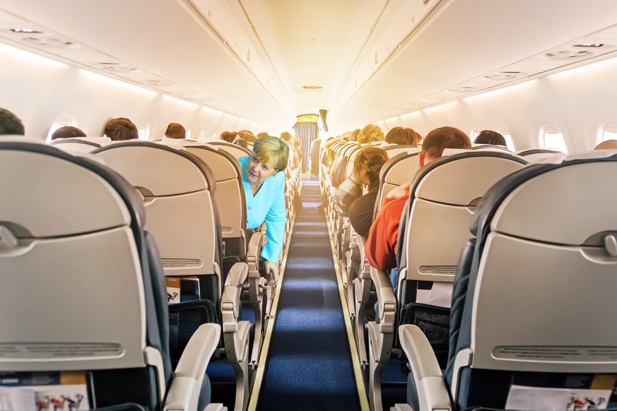 Commercial aircraft cabin with rows of seats down the aisle. morning light in the salon of the airliner. economy class