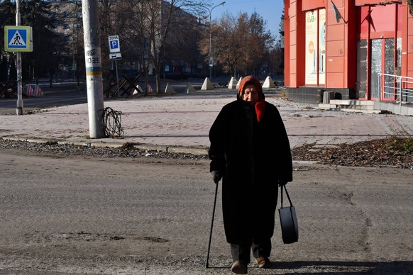 December 20, 2022, Bakhmut, Donetsk, Ukraine: An elderly woman walks along an empty and deserted street in the center of Bakhmut. President Volodymyr Zelensky said that Bakhmut in Donetsk Oblast remai ...