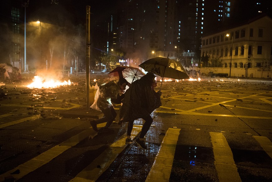 November 18, 2019, Hong Kong, China: Protesters clash with police outside Hong Kong Polytechnic University, where a police officer was shot in the leg with an arrow and an armoured vehicle was set on  ...