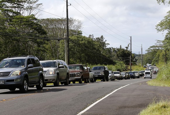 Residents of the Leilani Estates queue in a line to enter the subdivision to gather possessions from their homes, Sunday, May 6, 2018, in Pahoa, Hawaii. Scientists reported lava spewing more than 200  ...