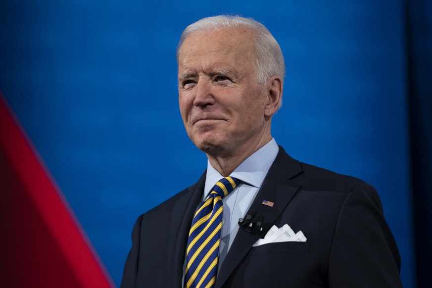 President Joe Biden talks with audience members as he waits for a commercial break to end during a televised town hall event at Pabst Theater, Tuesday, Feb. 16, 2021, in Milwaukee. (AP Photo/Evan Vucc ...