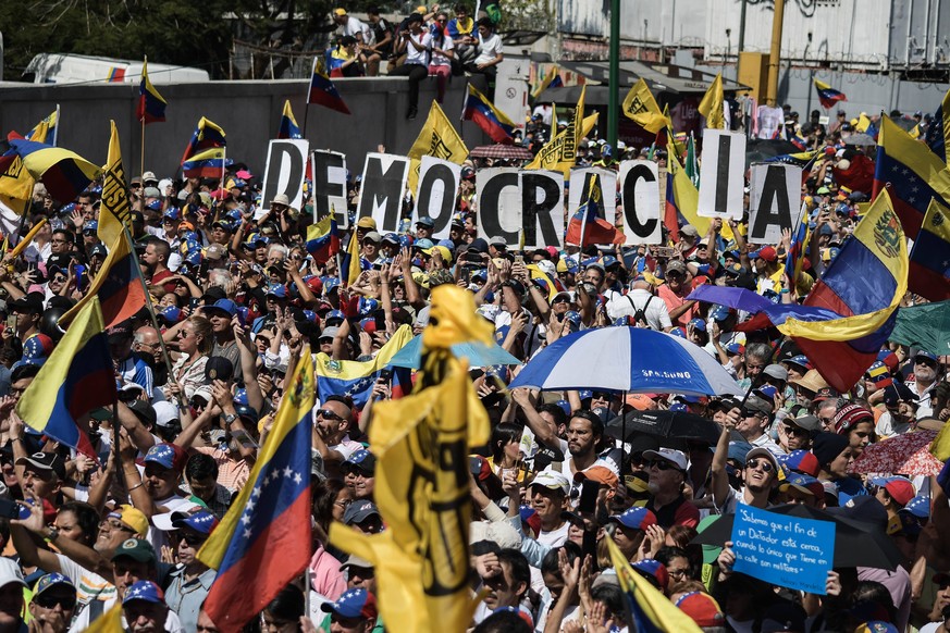 February 2, 2019 - Caracas, Miranda, Venezuela - Large crowd of president Juan Guaido s supporters seen holding several placards during a protest against Maduro. Opposition supporters take part in a r ...