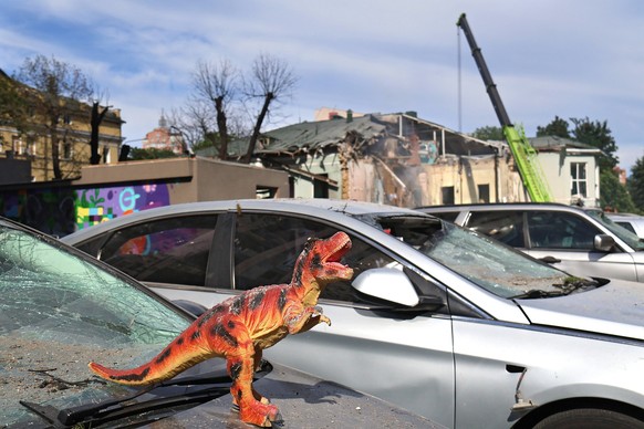 KYIV, UKRAINE - JULY 8, 2024 - A toy dinosaur is on the bonnet of a car at the Ohmatdyt National Specialized Childrens Hospital attacked by Russias Kh-101 strategic cruise missile, Kyiv, capital of Uk ...