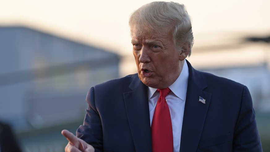 President Donald Trump talks with reporters before departing from Morristown Municipal Airport in Morristown, N.J., Sunday, Aug. 9, 2020. Trump was returning to Washington after spending the weekend a ...