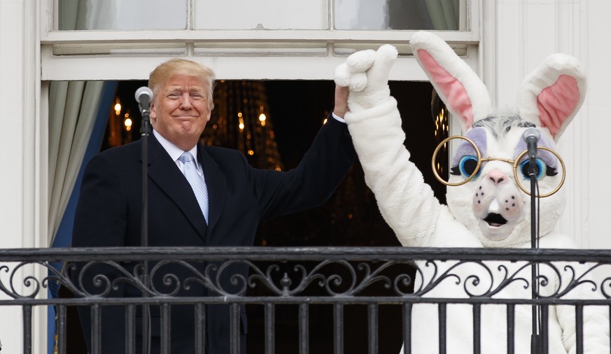President Donald Trump and the Easter Bunny stand together on the Truman Balcony at the White House in Washington, Monday, April 2, 2018, during the annual White House Easter Egg Roll. (AP Photo/Carol ...