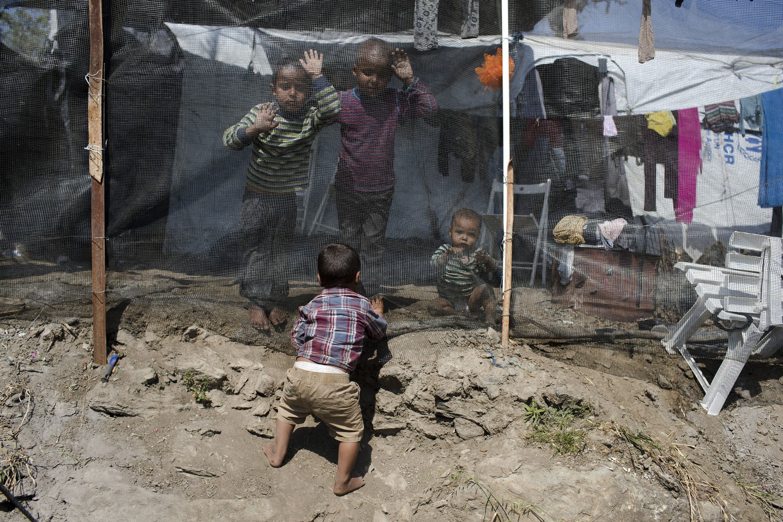Children play inside the Moria refugee camp on the northeastern Aegean island of Lesbos, Greece, Wednesday, May 2, 2018. Amid protests, the government has promised to drastically reduce overcrowding a ...
