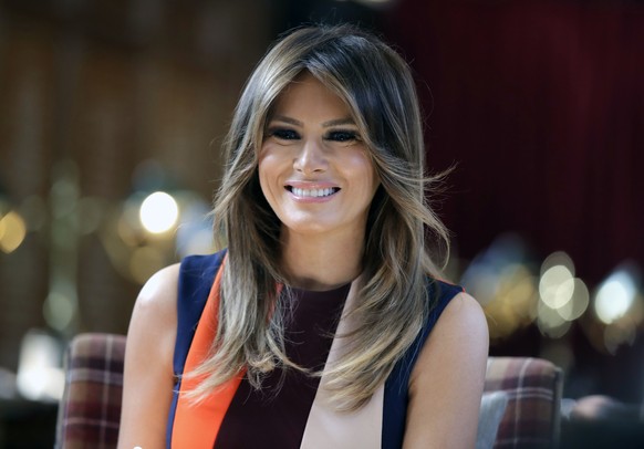 FILE - In this Friday, July 13, 2018 file photo, first lady Melania Trump takes a seat during a visit to The Royal Hospital Chelsea in central London. First lady Melania Trump stepped away from her hu ...