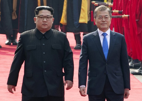 FILE - In this Friday, April 27, 2018, file photo, North Korean leader Kim Jong Un, left, and South Korean President Moon Jae-in inspect an honor guard after Kim crossed the border into South Korea fo ...