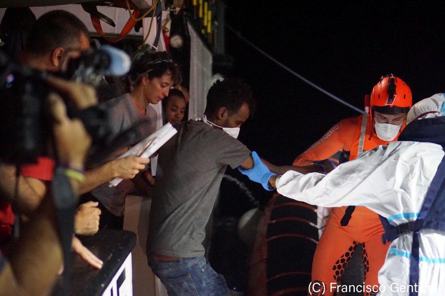 Migrants evacuated by a Spanish rescue ship Open Arms disembark at Lampedusa, Italy in this undated handout picture provided by the Spanish NGO Open Arms on August 19, 2019. Francisco Gentico/Open Arm ...