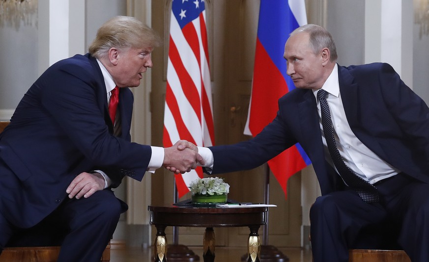 U.S. President Donald Trump, left, and Russian President Vladimir Putin, right, shake hand at the beginning of a meeting at the Presidential Palace in Helsinki, Finland, Monday, July 16, 2018. (AP Pho ...