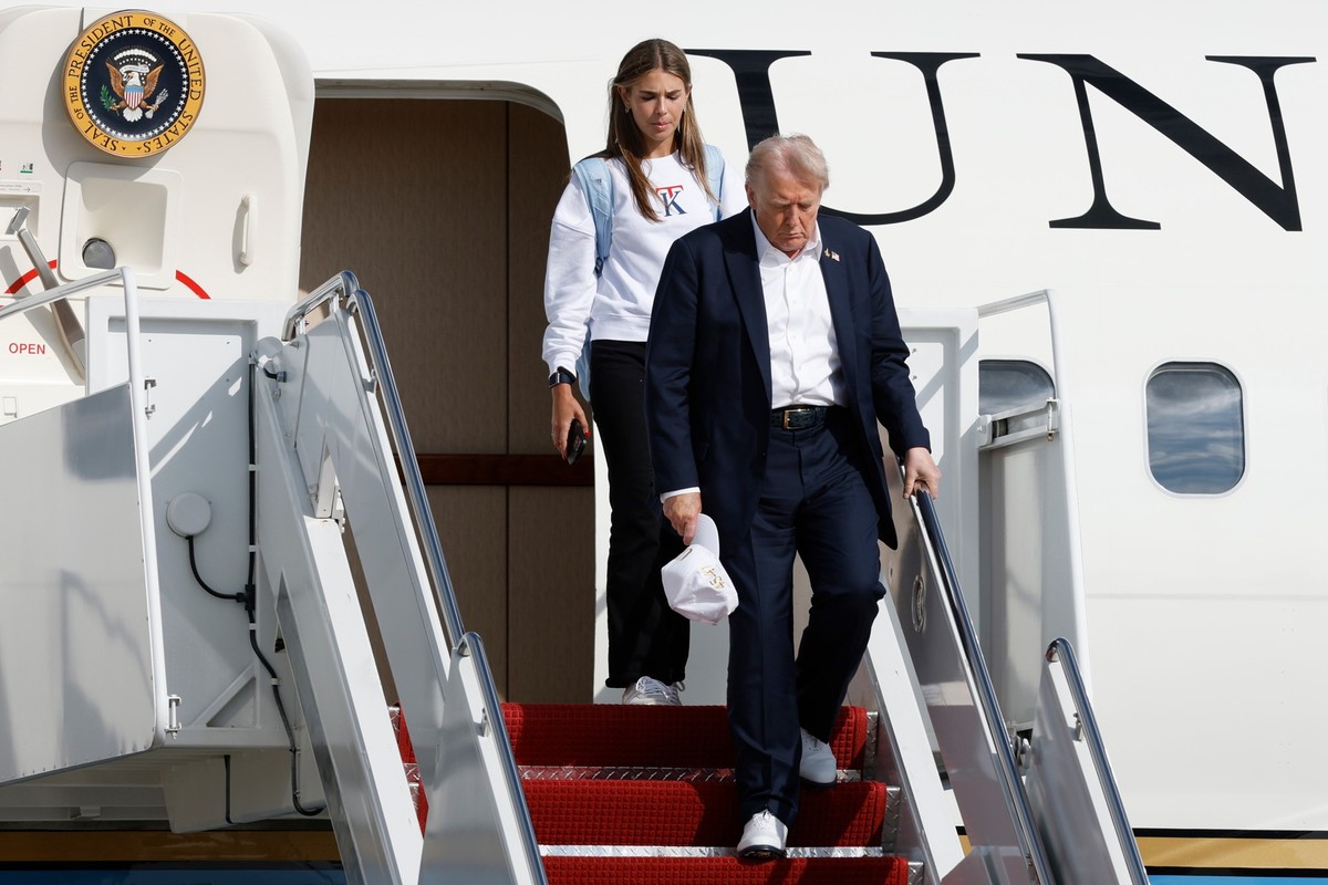 President Donald Trump, front right, walks down the stairs of Air Force One with his granddaughter Kai Trump upon arriving at Joint Base Andrews, Md., Friday Sept. 26, 2025, after a day trip to the Ry ...
