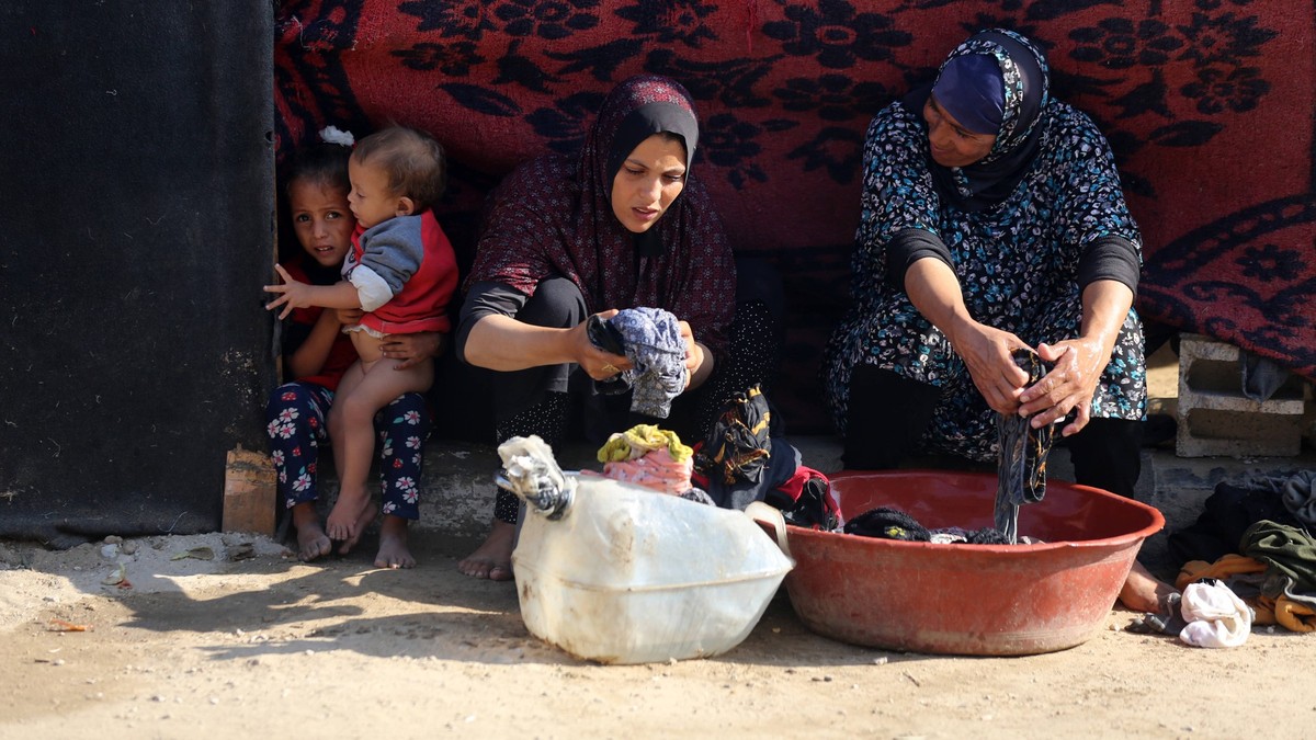 Daily LIfe In Gaza Amid Hamas-Israel Conflict Palestinian women wash their clothes at a makeshift camp for the internally displaced in Deir al-Balah, Gaza Strip, on October 18, 2024, amid the ongoing  ...