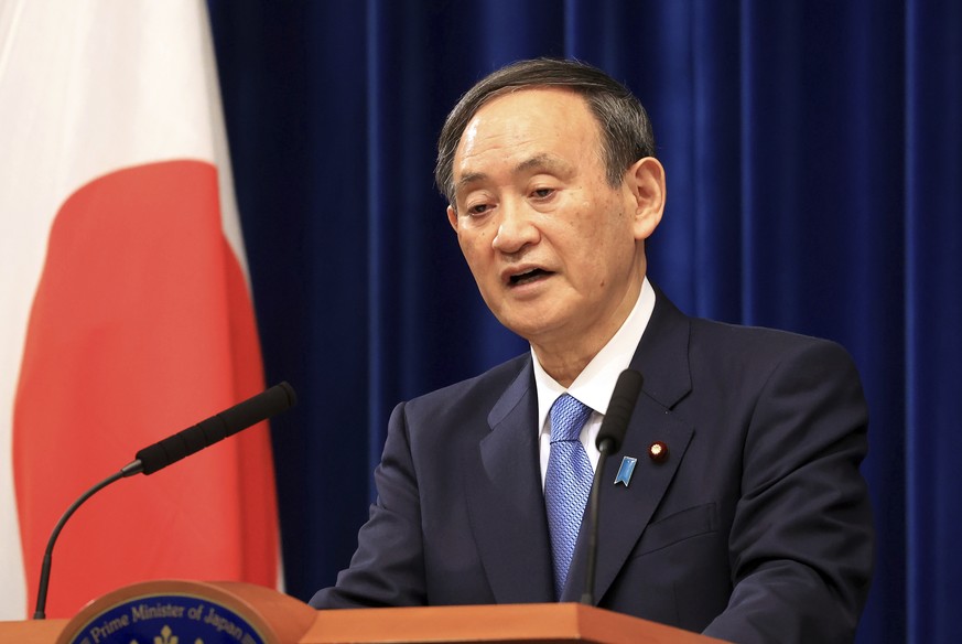 Japanese Prime Minister Yoshihide Suga holds a New Year&#039;s press conference at his official residence in Tokyo Monday, Jan. 4, 2021. Suga said Monday vaccine approval was being speeded up and bord ...