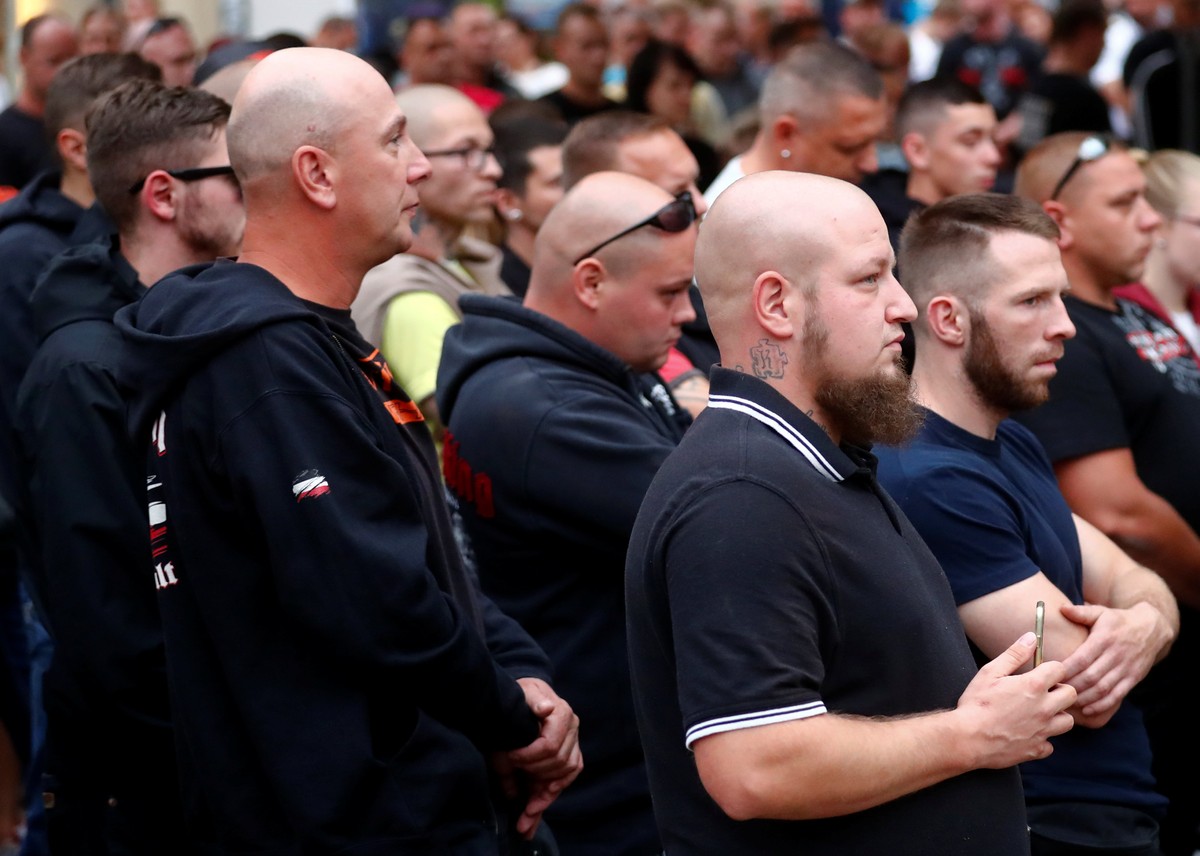 People attend a minute of silence during a gathering after a 22-year-old German man died in the eastern town of Koethen and two Afghans have been detained on suspicion of killing him, in Koethen, Germ ...