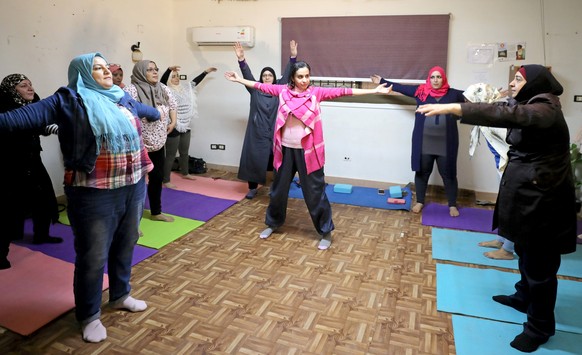 Syrian refugees and Egyptian women practise yoga at a United Nations Population Fund, safe space for refugee women and girls residing in Cairo, Egypt October 29, 2018. Picture taken October 29, 2018.  ...