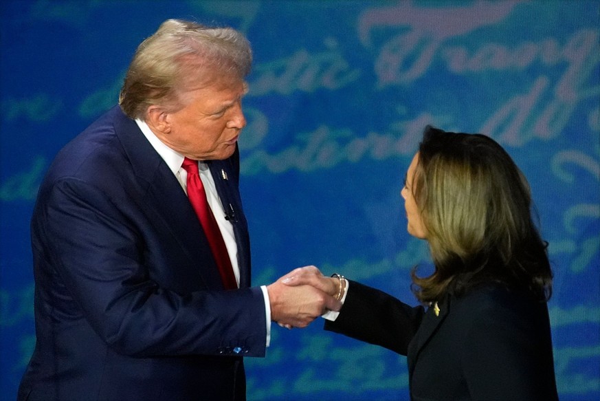 Republican presidential nominee former President Donald Trump shakes hands with Democratic presidential nominee Vice President Kamala Harris during an ABC News presidential debate at the National Cons ...