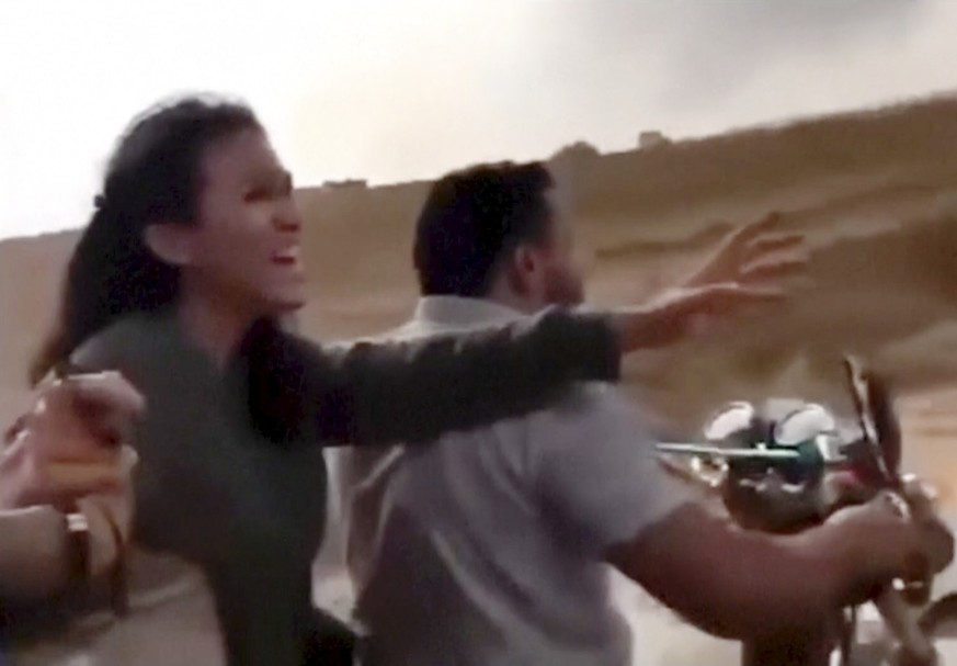 In this image from video obtained by the AP, Noa Argamani reacts as she and her partner Avinatan Or, not pictured, are seized by members of the Hamas militant group during an incursion into Israel on  ...