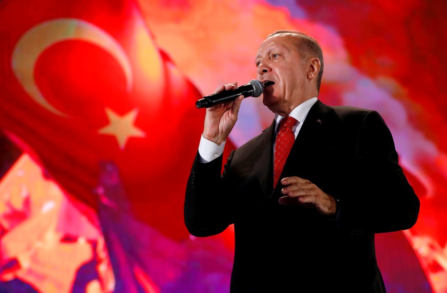 FILE PHOTO: FILE PHOTO: Turkish President Tayyip Erdogan addresses his supporters during a ceremony marking the third anniversary of the attempted coup at Ataturk Airport in Istanbul, Turkey, July 15, ...