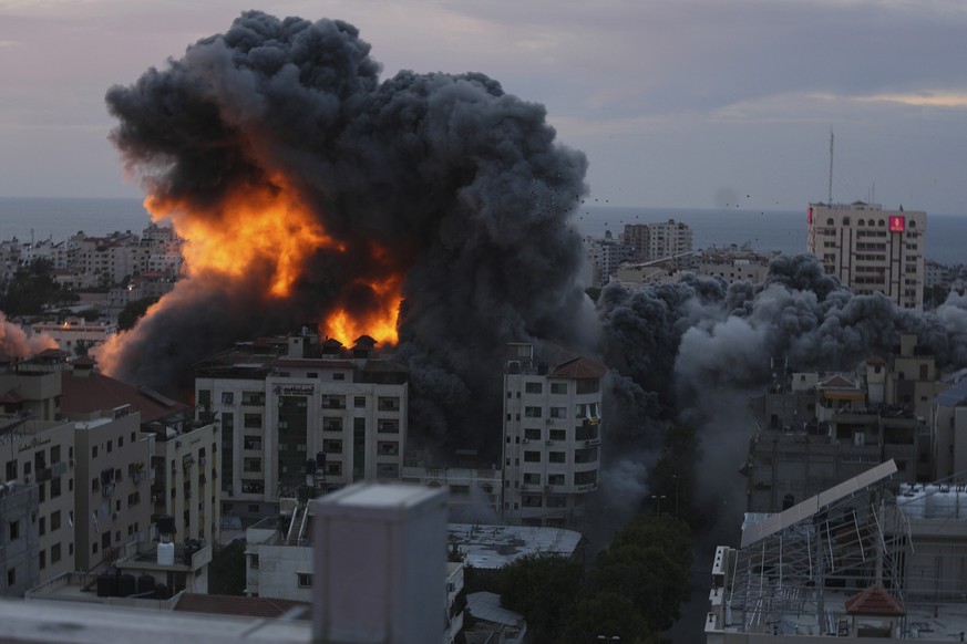 Fire and smoke rise from an explosion on a Palestinian apartment tower following an Israeli air strike in Gaza City, Saturday, Oct. 7, 2023. The militant Hamas rulers of the Gaza Strip carried out an  ...