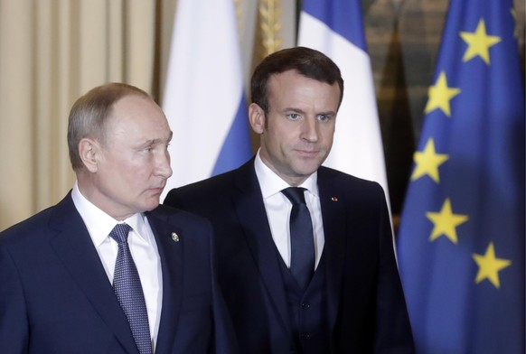 PARIS, FRANCE DECEMBER 9, 2019: Russia s President Vladimir Putin L, and France s President Emmanuel Macron attend a Normandy Four summit in the Murat Lounge in the Elysee Palace talks in the so-calle ...