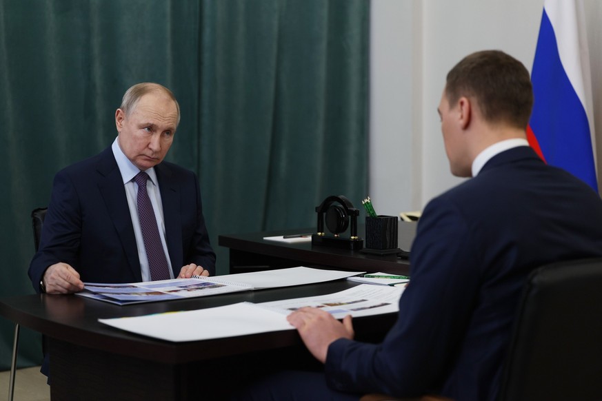 Russian President Vladimir Putin, left, meets with Khabarovsk Region Governor Mikhail Degtyarev, right, in Khabarovsk, Russia, Thursday, Jan. 11, 2024. (Gavriil Grigorov, Sputnik, Kremlin Pool Photo v ...