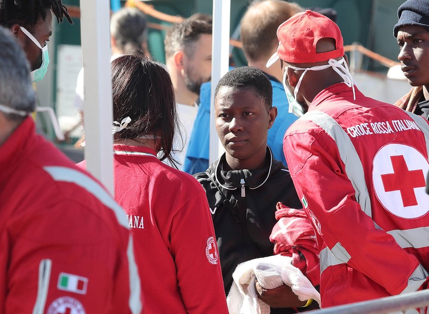 April 2, 2018 - Messina, ME, Italy - Men and women wait to disembark a navy which transports severals immigrants in the port of Messina, on the island of Sicily, on April 02, 2018 after a rescue opera ...