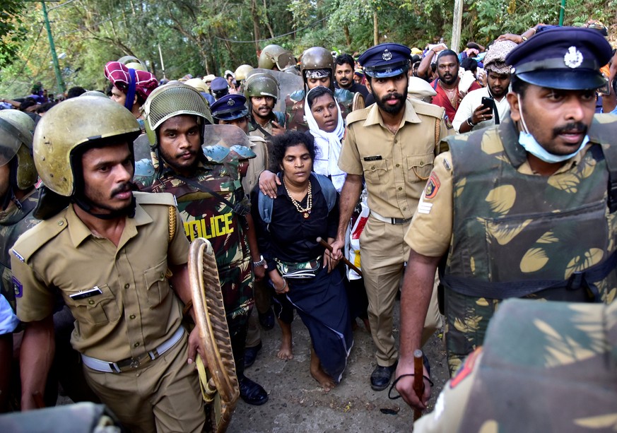 Bindu Ammini, 42, and Kanaka Durga, 44, are escorted by police after they attempted to enter the Sabarimala temple in Pathanamthitta district in the southern state of Kerala, India, December 24, 2018. ...