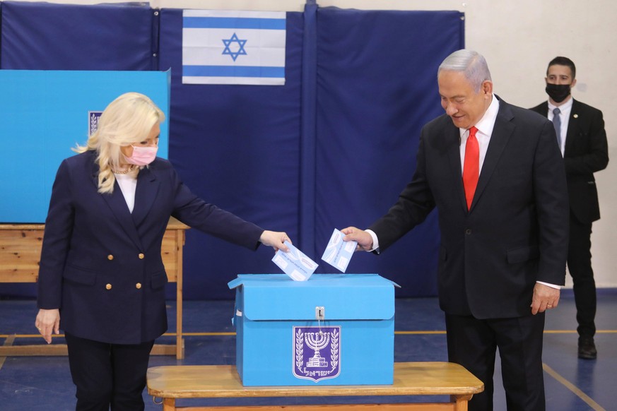 210323 -- JERUSALEM, March 23, 2021 -- Israeli Prime Minister Benjamin Netanyahu casts his vote during the Israeli parliamentary elections in Jerusalem on March 23, 2021. Israelis began casting their  ...