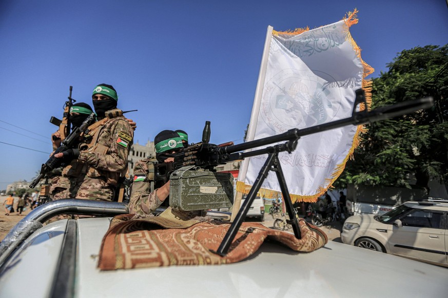 July 19, 2023, Gaza, Palestine: Palestinian fighters from the military wing of the Hamas movement seen on the back of a truck during a military parade near the border with Israel in the central Gaza S ...