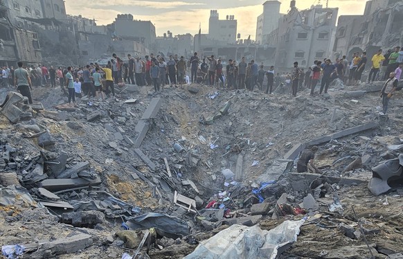 Palestinians search for victims in the rubble after Israeli airstrikes on Jabalia refugee camp in northern Gaza, on Tuesday, October 31, 2023. Dozens of Palestinians, including children were killed in ...