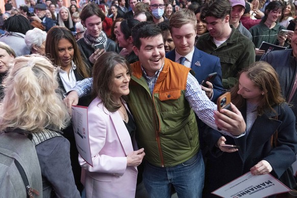 Self-help author Marianne Williamson takes a photo with a supporter as she launches her 2024 presidential campaign in Washington, Saturday, March 4, 2023. The 70-year-old onetime spiritual adviser to  ...