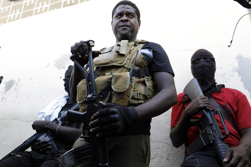 Barbecue, the leader of the &quot;G9 and Family&quot; gang, stands with his fellow gang members after speaking to journalists in the Delmas 6 neighborhood of Port-au-Prince in Port-au-Prince, Haiti, T ...