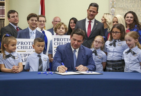 FILE - Florida Gov. Ron DeSantis signs the Parental Rights in Education bill at Classical Preparatory school on March 28, 2022, in Shady Hills, Fla. Florida Republicans on Tuesday, March 14, 2023, adv ...