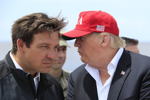 FILE - President Donald Trump talks to Florida Gov. Ron DeSantis, left, during a visit to Lake Okeechobee and Herbert Hoover Dike at Canal Point, Fla., March 29, 2019. Allies of former President Donal ...