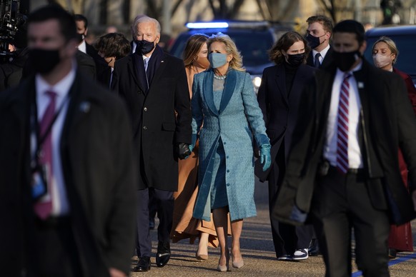 President Joe Biden walks with first lady Jill Biden during the Presidential Escort, part of Inauguration Day ceremonies, Wednesday, Jan. 20, 2021, in Washington. (AP Photo/Evan Vucci)