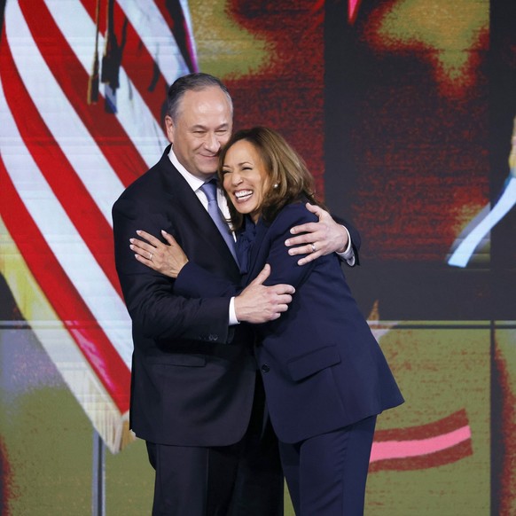 Second gentleman Doug Emhoff, left, hugs Democratic presidential nominee Vice President Kamala Harris during the final day of the Democratic National Convention Thursday, Aug. 22, 2024 in Chicago. (Ga ...