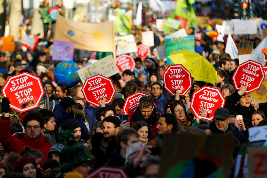 People holding placards shout slogans during the Global Climate Strike of the movement Fridays for Future, in Cologne, Germany, November 29, 2019. REUTERS/Thilo Schmuelgen